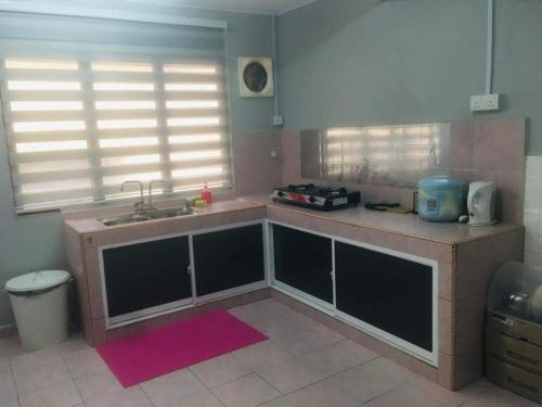 a kitchen with a sink and a counter top at Home2Stay Damia @ Bukit Katil in Malacca