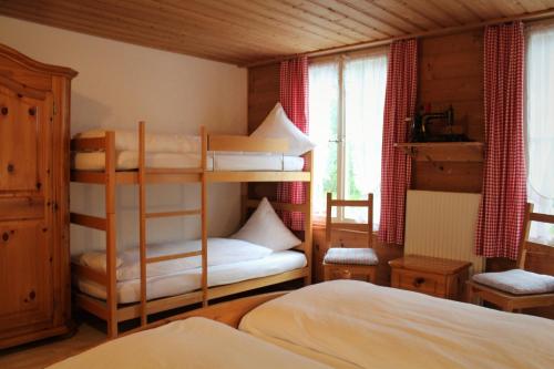 a bedroom with two bunk beds in a room at Gasthof Schoenegg B&B in Goldswil