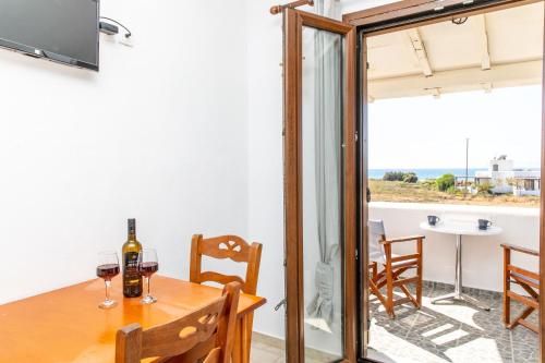 a dining room with a table with wine glasses at Studio Tolakis in Plaka