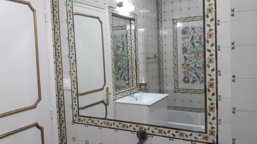 a bathroom with two mirrors and a sink at Lx Art Flats | Flat Two in Lisbon