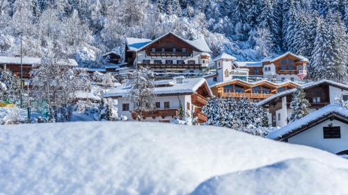 a resort in the mountains covered in snow at Aparthotel Gallahaus in Zell am Ziller