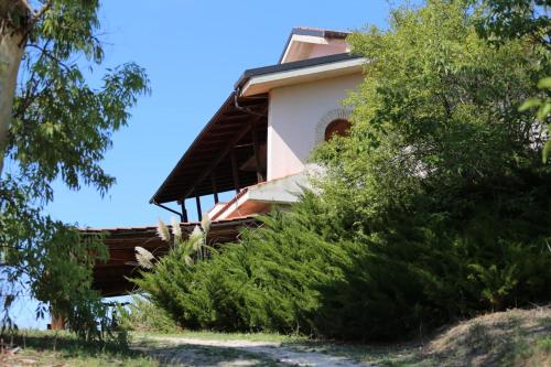 a house on top of a hill with bushes at Manuel suites in Pianella