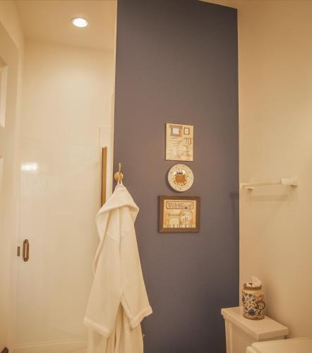 a bathroom with a toilet and a towel on the wall at Hill of Content B&B in Radiant