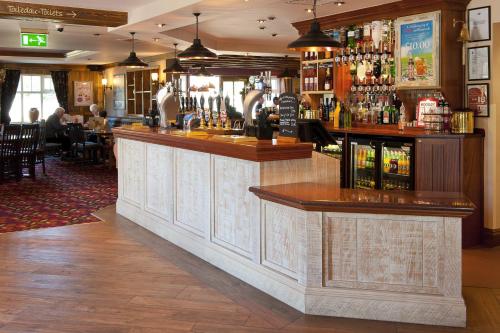 a bar in a restaurant with people sitting at tables at Starling Cloud in Aberystwyth