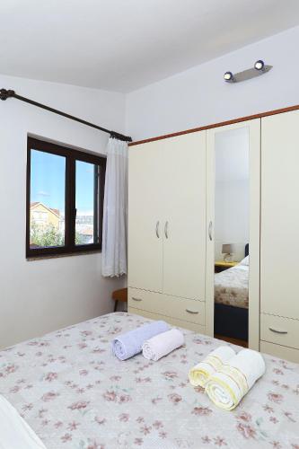 Ένα ή περισσότερα κρεβάτια σε δωμάτιο στο Apartments Vedrana