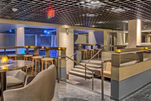 a restaurant with a table and chairs and stairs at Omni Houston Hotel in Houston