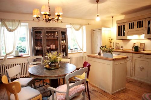 a kitchen with a table and chairs in a room at U Květů in Milešov