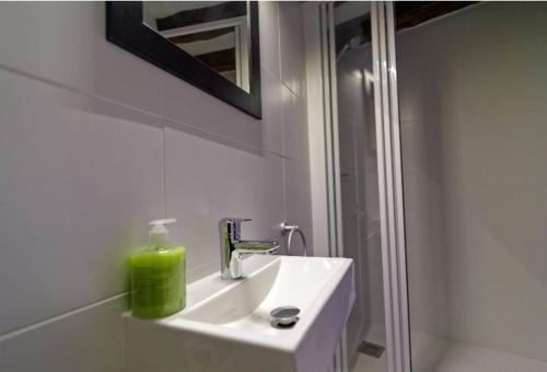 a white bathroom with a sink and a shower at La Bodega de Puy in Graus