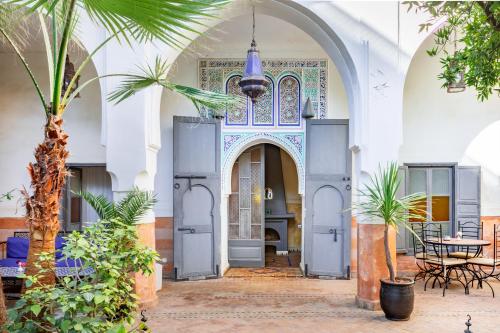 an entry to a mosque with a palm tree at Riad Laila in Marrakech
