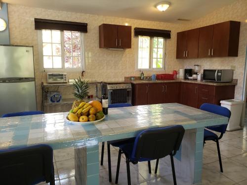 una cocina con una mesa con un bol de fruta. en Villa San Antonio - El Valle de Anton en El Valle