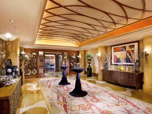 a lobby with two black vases on a rug at Sofitel Macau At Ponte 16 in Macau