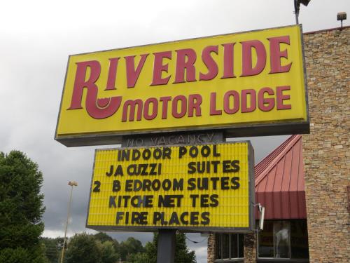 a sign for a motorcycle motor lodge in front of a store at Riverside Motor Lodge - Pigeon Forge in Pigeon Forge