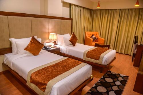 Postel nebo postele na pokoji v ubytování Hotel Indo Prime