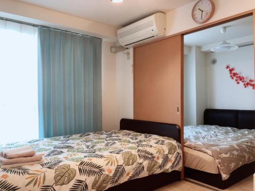 a bedroom with a bed and a window at Near Nakajima park Close to Susukino Anbiennte 101 in Sapporo