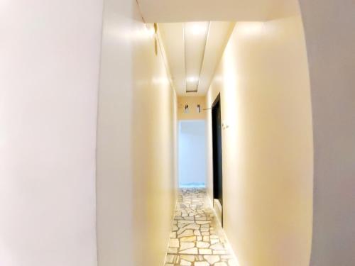 a hallway with a walkway with a view of the ocean at City Hotel in Allahābād