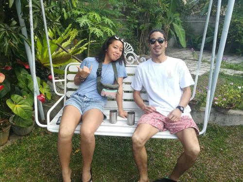 a man and a woman sitting on a white bench at CHEN VILLA - Near Airport in Negombo