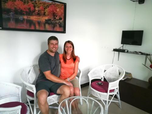 a man and a woman sitting in chairs at CHEN VILLA - Near Airport in Negombo