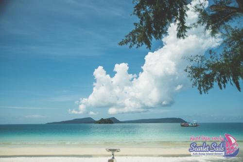 a view of a beach with a boat in the water at Scarlet Sails Resort in Koh Rong Island