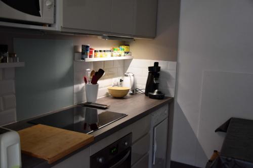 a kitchen with a sink and a counter top at Charmant Studio au calme à 5 min du centre ville in Saint-Claude