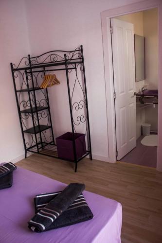 a bedroom with a bed with a mirror on the wall at Colors Rooms in Valencia