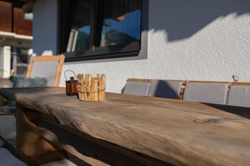 a wooden table with a candle on top of it at Apart Tyrol in Uderns