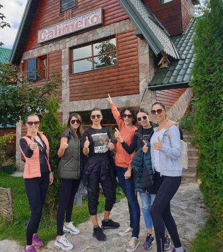 a group of women standing in front of a building at Holiday Home Vile Calimero in Žabljak