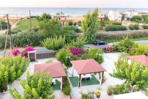 an overhead view of a garden with the ocean in the background at Luxury Suites in Stavromenos in Stavromenos