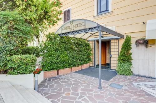 a sign for a hotel room in front of a building at Romoli Hotel in Rome