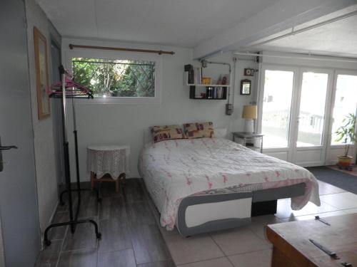 Feytiatにあるla maison bonheurの窓付きの部屋にベッド付きのベッドルーム1室があります。
