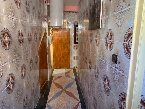 a hallway with tiled walls and a tile floor at Quiet Apartment in El Ksiba / Beni Mellal in El Ksiba