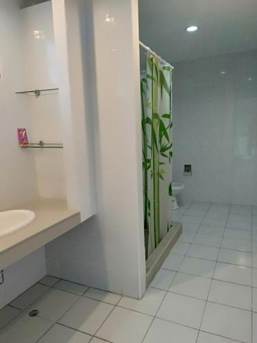 a bathroom with a shower and a sink and a toilet at Amy's beach apartments in Rayong