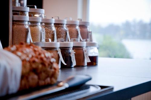 a group of jars of honey sitting on a counter at Hasse på Sjökanten Hotell & Restaurang in Jönköping