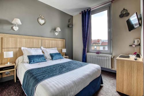 a hotel room with a large bed and a window at Cit'Hotel La Résidence in Nancy