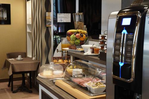 a buffet line with food on display in a restaurant at Cit'Hotel La Résidence in Nancy