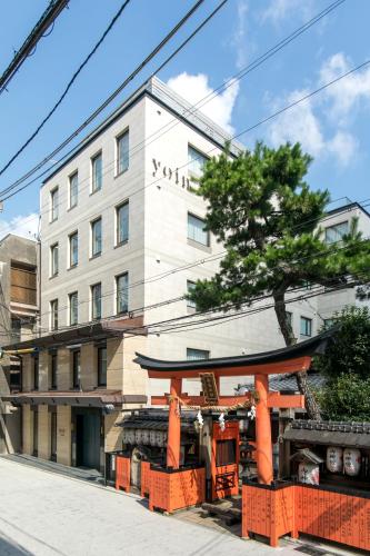 a building on a street in front of a building at yoin hotel kyoto gion in Kyoto
