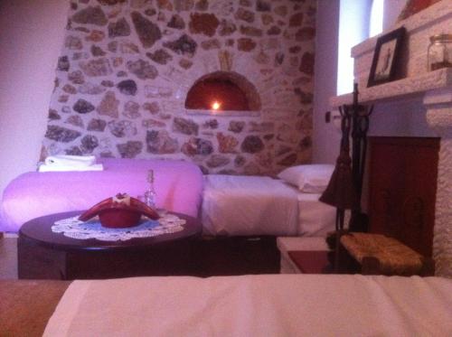 a room with a bed and a table with a cake at Yono's Traditional House in Ano Ravenia