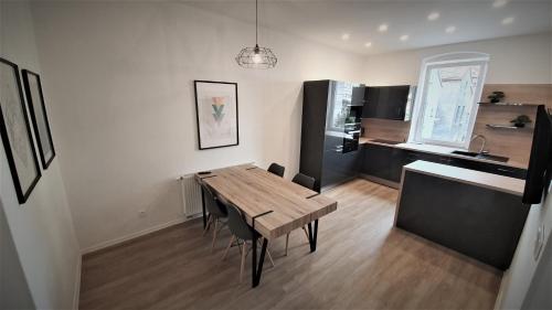 a kitchen and dining room with a wooden table and chairs at Jacob´s Apartement in Pilsen