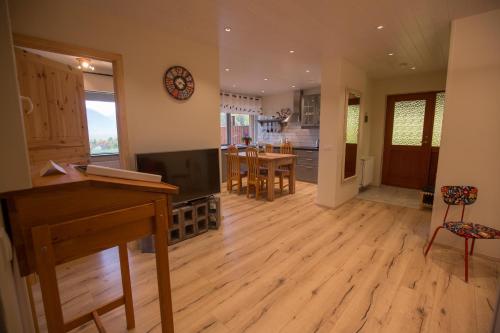 a living room with a television and a dining room at Hestasport Apartment in Varmahlid