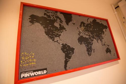 a poster of the world hanging on a wall at Hestasport Apartment in Varmahlid