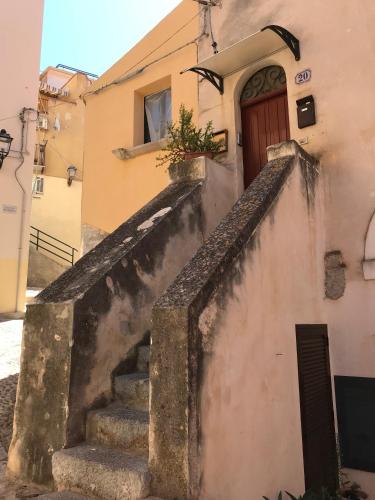 a set of stairs leading up to a building with a door at Saraceni 20 in Cefalù