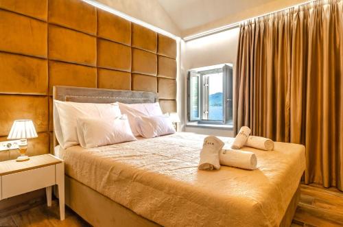 a bedroom with a bed with two towels on it at Villa Gabriela in Korčula