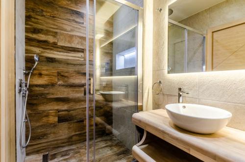 a bathroom with a sink and a glass shower at Villa Gabriela in Korčula