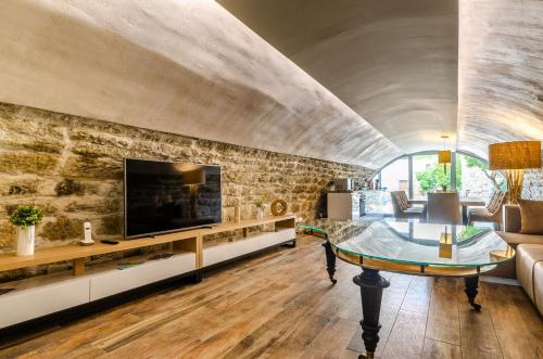 a living room with a stone wall at Villa Gabriela in Korčula