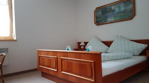 a room with a wooden bed with pillows on it at Wohlfühl - Appartement Fewo Pichlarn Irdning Ferienwohnung in Aigen im Ennstal
