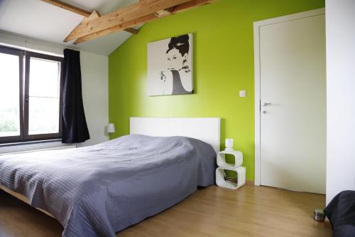 Ένα ή περισσότερα κρεβάτια σε δωμάτιο στο De Lucarne