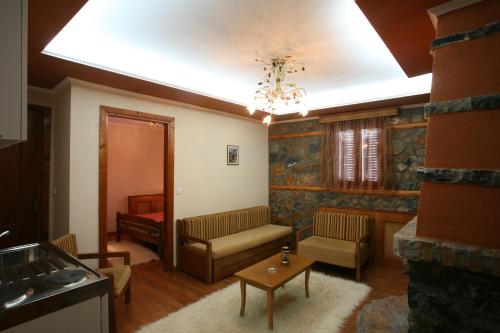 a living room with a couch and a table at Exohiko in Palaios Agios Athanasios