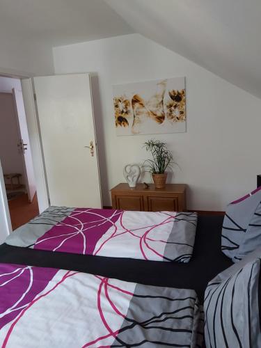 a bedroom with a bed with a colorful comforter at Ferienwohnung Blütenstadt Werder-Havel in Werder