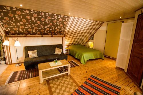 a living room with a couch and a bed at Omakoda in Vanamõisa