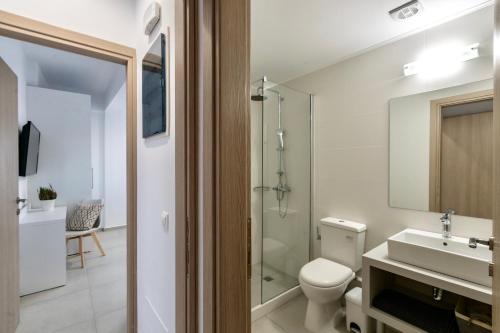 a bathroom with a toilet and a sink and a shower at Villa Izabela in Hersonissos