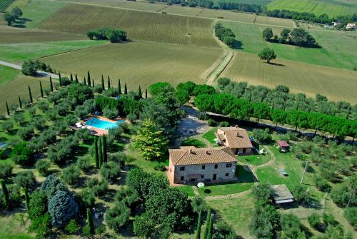 an aerial view of a house with a pool and trees at Poggio del Sole in Castiglione del Lago